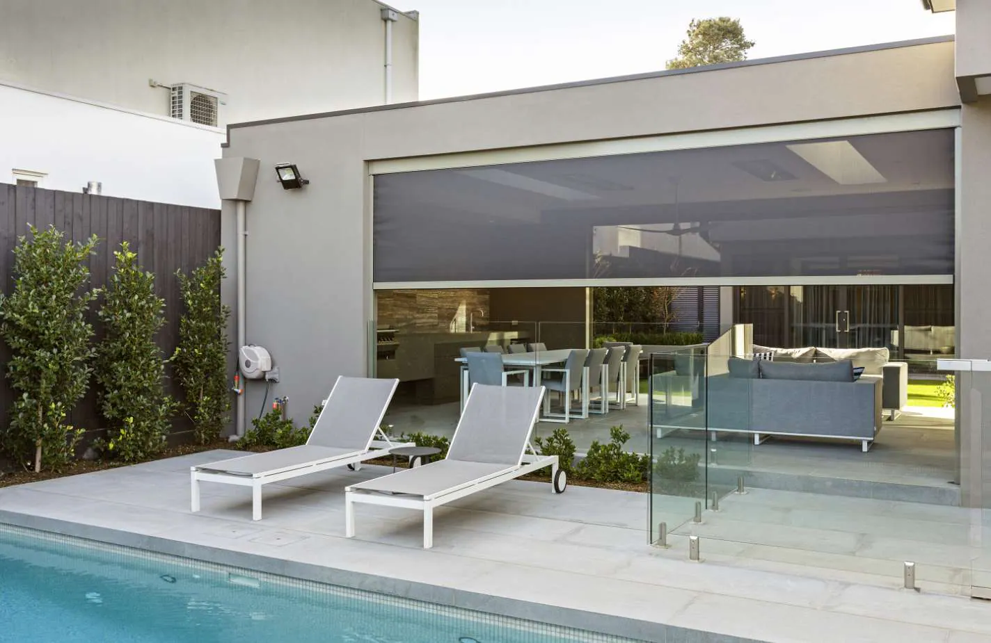 Zipscreen outdoor blinds enclosing a poolside alfresco area