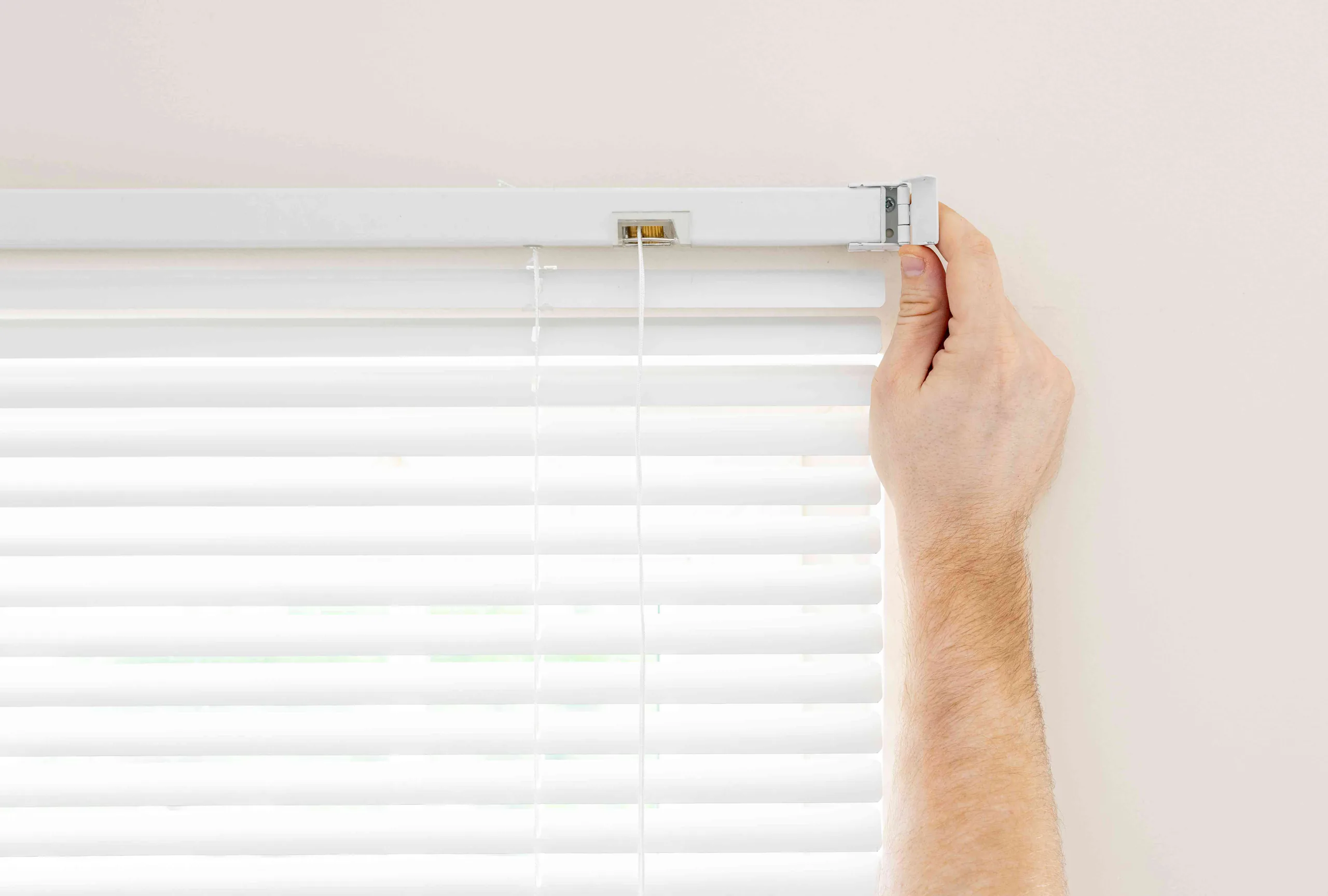 Sheerview consultant measuring windows in a Gold Coast home